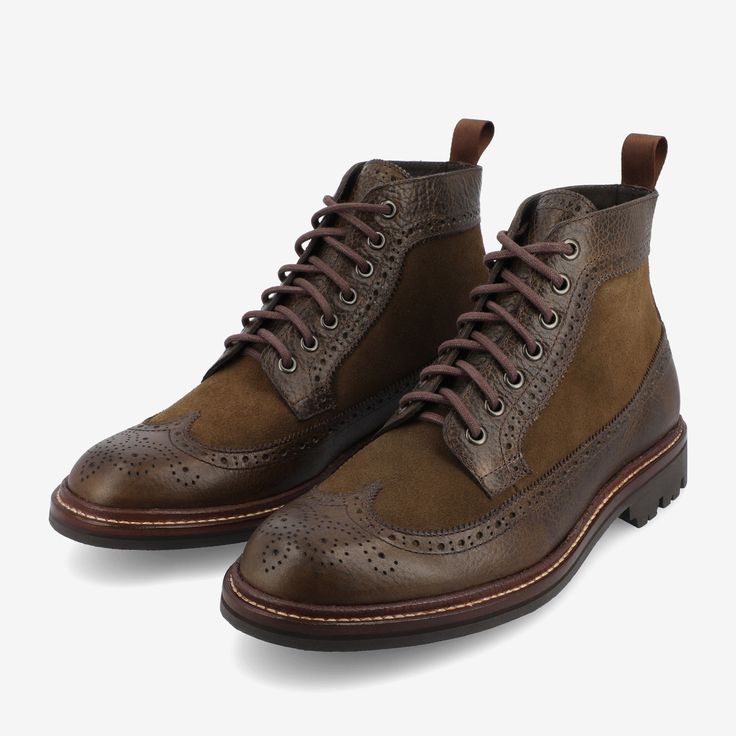 The Boston Boot in Olive from TAFT captures the essence of the iconic long-wing brogue style, creating a moment of class. Featuring a full-grain leather upper complemented by wool tweed sourced from Scotland, the boot fuses traditional craftsmanship with a contemporary look. Its leather-lined interior enhances comfort and style, while the rubber commando sole provides reliable traction for various terrains. The Blake-stitched construction adds to the boot's allure, making the Boston men's boot a Brown Wingtip Lace-up Boots With Goodyear Welt, Brown Goodyear Welted Wingtip Lace-up Boots, Brown Wingtip Lace-up Boots Goodyear Welted, Classic Wingtip Boots With Suede Lining, Suede Wingtip Boots With Brogue Detailing, Leather Wingtip Boots With Suede Lining, Fall Wingtip Lace-up Boots With Leather Lining, Brown Brogue Lace-up Boots For Derby, Fall Wingtip Lace-up Boots