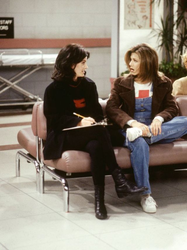 two women sitting on a couch talking to each other