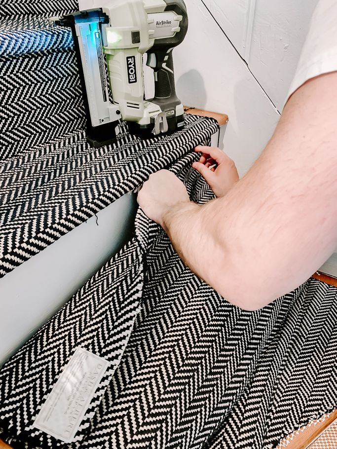 a person cutting fabric with a sewing machine