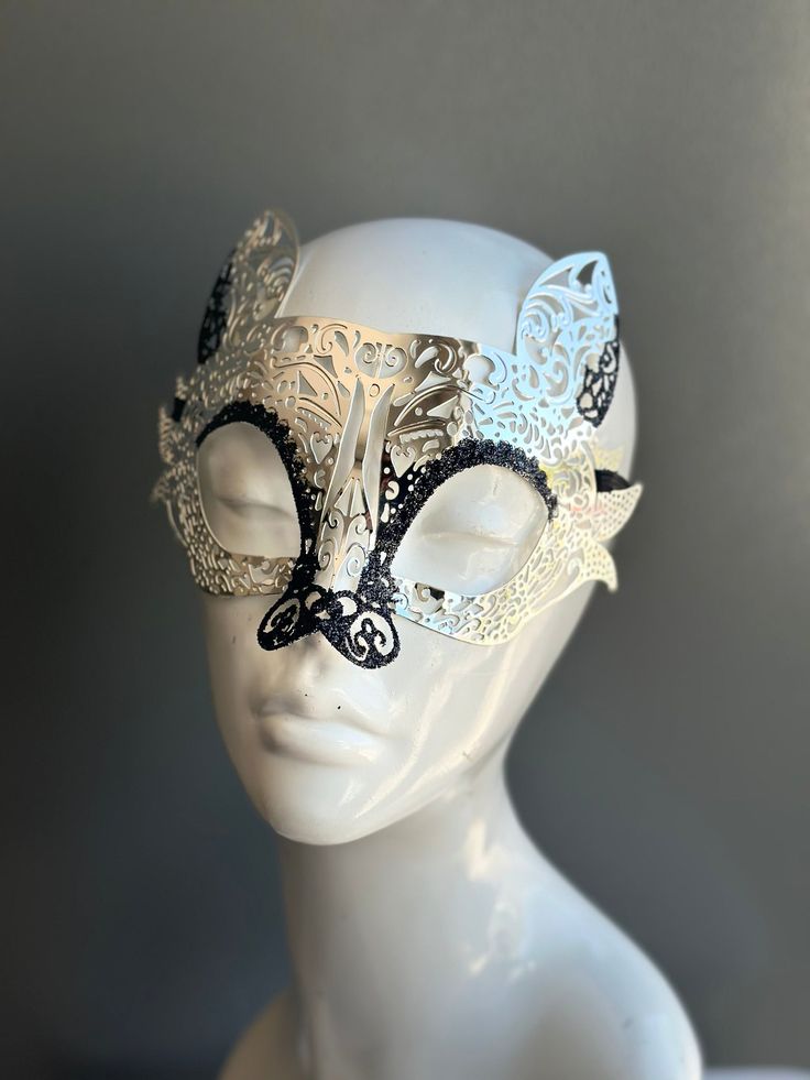 This mask takes inspiration from the elusive and enchanting lemur, adding a touch of intrigue and mystique to your look. The striking contrast of silver with black glitter exudes an air of opulence and charm. Whether you're attending a grand masquerade ball, a themed gala, or simply looking to add a touch of exotic elegance to your attire, this mask ensures you'll be the center of attention.


Age Group/Gender - Adult/Unisex

Size/Type - One size fits all adults

Mask Color - Silver/Black

Mask