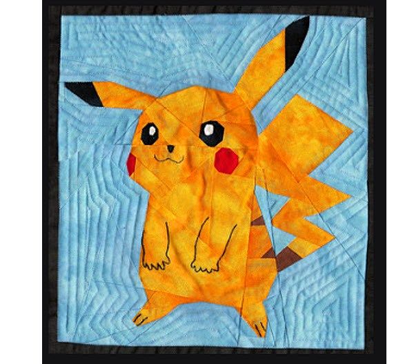 a close up of a quilt with a pikachu on it