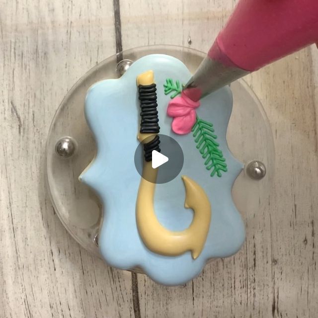 someone is using a plastic toothbrush holder to decorate their teeth with fondant and icing