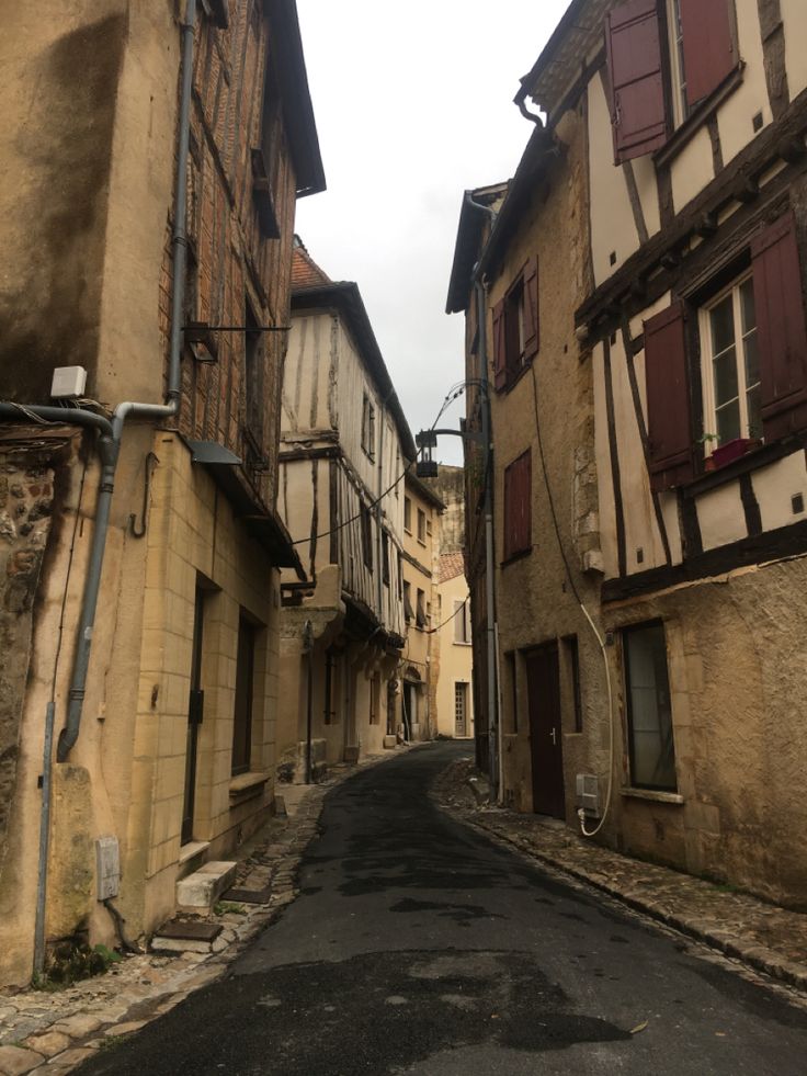 an empty street with old buildings on both sides