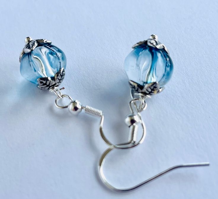 Beautiful 8mm blue and clear glass pumpkins , perfect size for all ages . Dark blue with light blue hues seen throughout hanging from Silvertone fish hook ear wires . Great for fall , Halloween gifts for her. Free shipping eligible with $35 order  Thanks for stopping by ! I appreciate your business! Hope you come back for your Holiday shopping and share my shop with friends ! Ocean-inspired Blue Earrings For Gifts, Handmade Blue Ocean-inspired Earrings, Handmade Blue Glass Earrings, Blue Handmade Dangle Clip-on Earrings, Blue Wire-wrapped Glass Earrings, Pumpkin Earrings, Glass Pumpkins, Ear Wires, Blue Hues