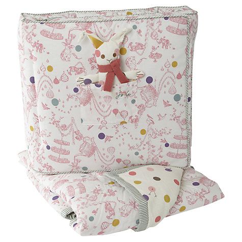 a pink and white blanket with an unicorn design on the front, sitting next to two pillows