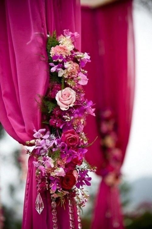 an image of flowers on the side of a pink drape with text that reads, q mandap route flowers