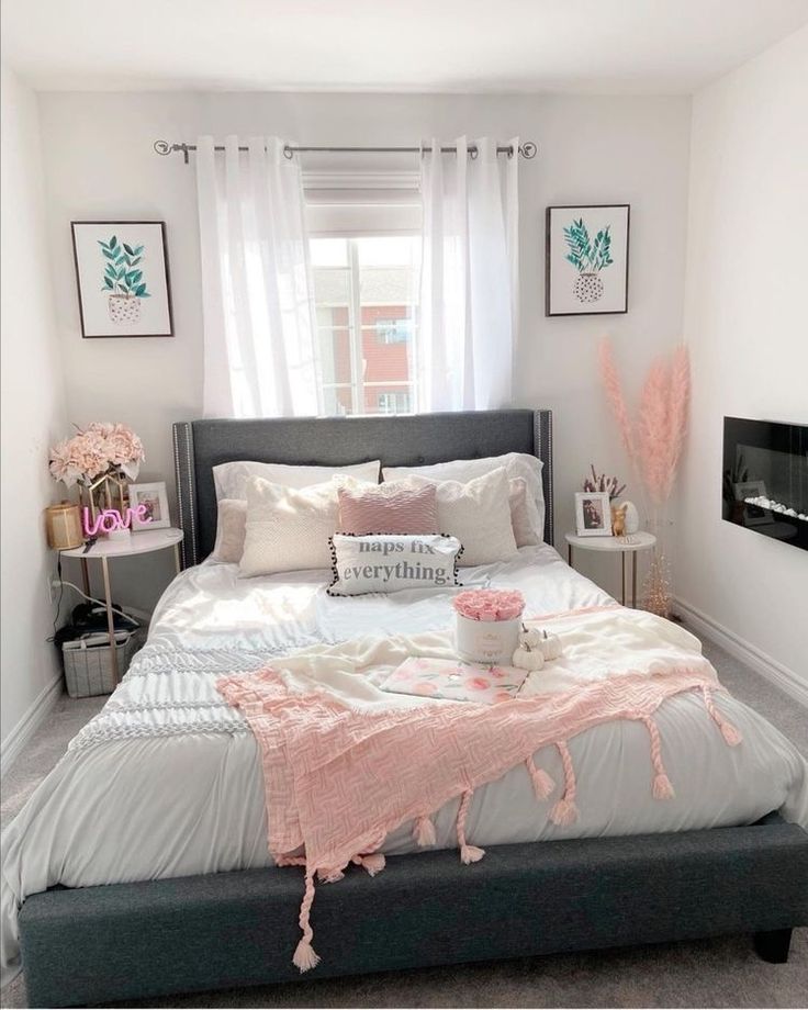 a white and gray bedroom with pink accents