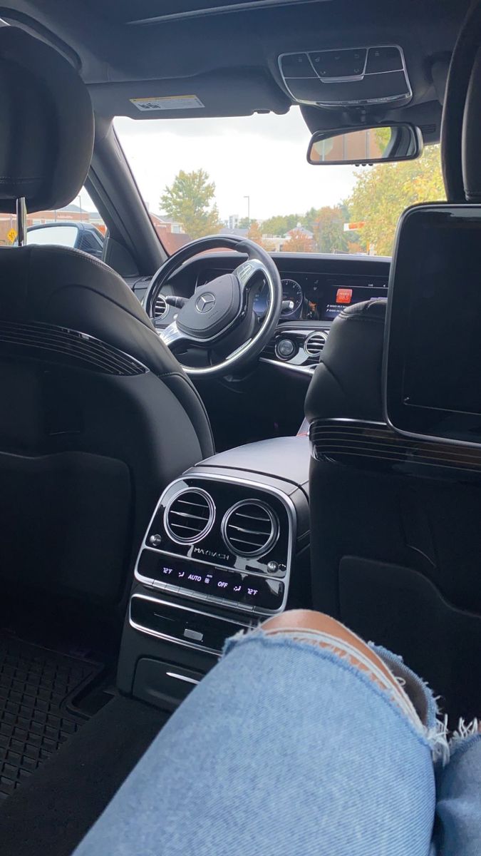 the interior of a car with black leather and blue denims on it's floor