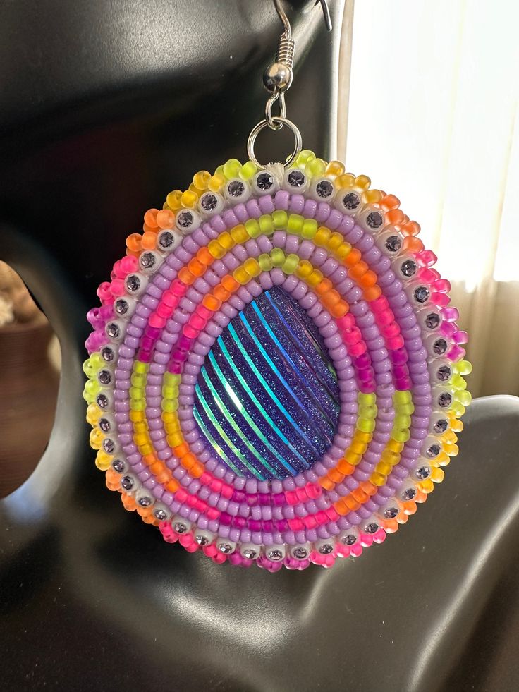 a pair of earrings made out of beads