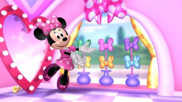 minnie mouse dancing in front of a mirror with lights on it's face and ears