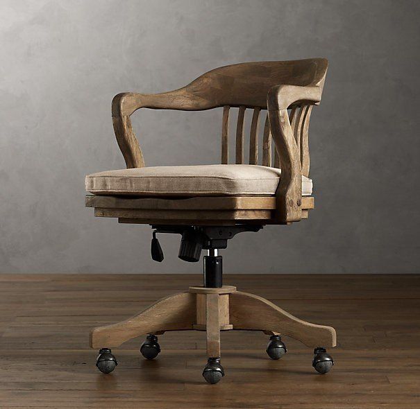 an office chair sitting on top of a wooden table