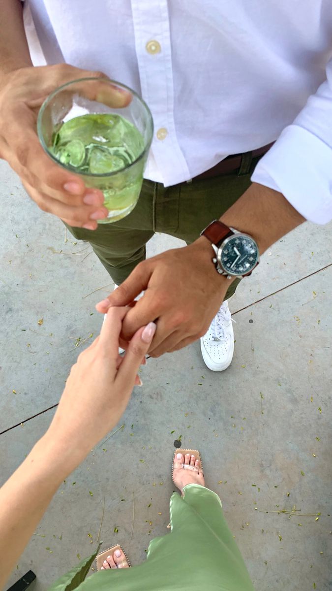 two people holding hands over a bowl of water