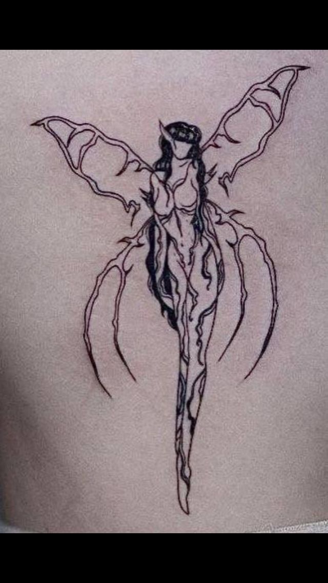 a woman's back with a tattoo design on it