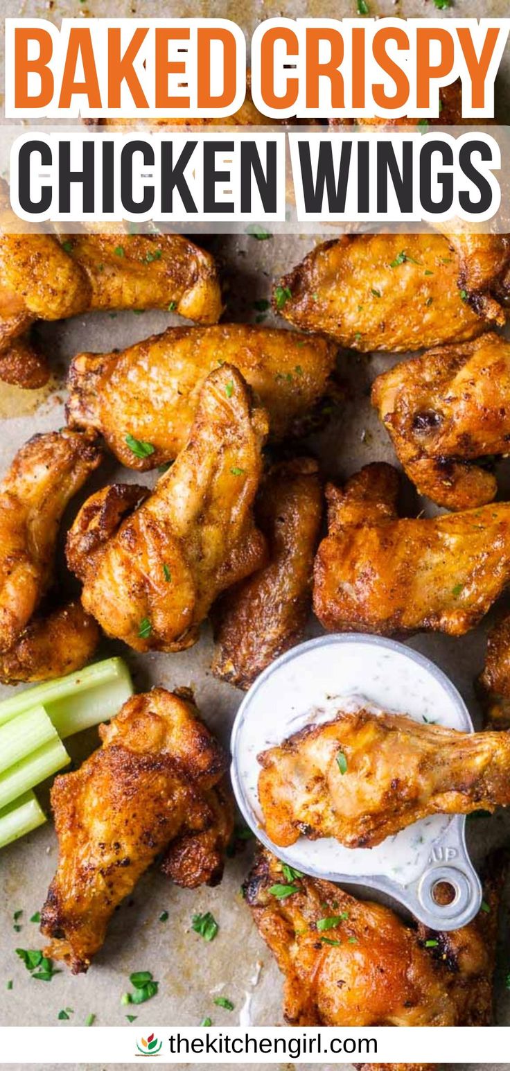 image of crispy baked chicken wing dipping into ranch dressing next to pile of wings and celery sticks on parchment paper. Title text: Baked Crispy Chicken Wings How To Make Wings Crispy In Oven, Healthy Baked Wings Oven, Baked Chicken Wings Oven Easy, Crispy Oven Baked Chicken Wings Corn Starch, Oven Fried Chicken Wings Baking Soda, Over Baked Chicken Wings, Baked Chicken Party Wings Recipes, Bone In Chicken Wings Oven Baked, Chicken Wings In Oven Recipes