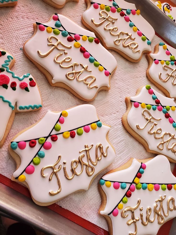 decorated cookies are sitting on a tray