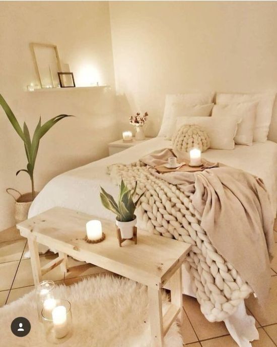 a bedroom with candles and blankets on the bed