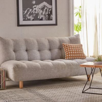 a living room with a gray couch and coffee table in front of a large window