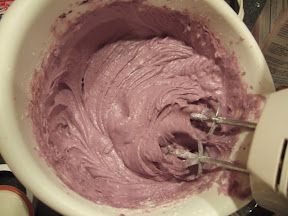 a mixing bowl filled with pink colored batter