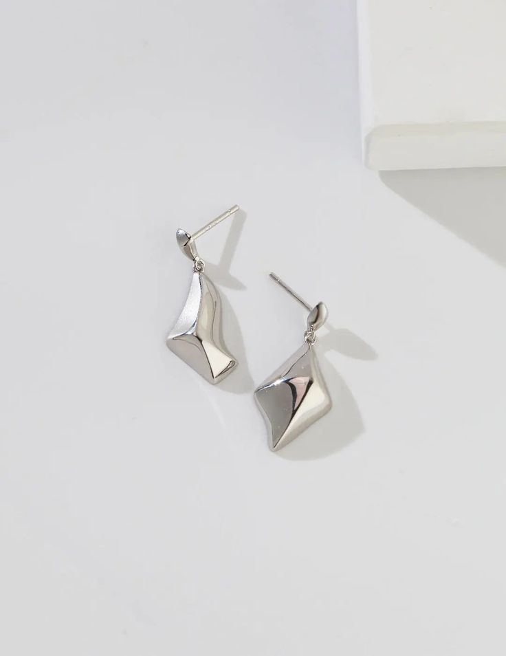 Suzanne Rhombus Drop Stud Earrings These earrings are perfect for making a statement! The irregular rhombus abstract design is eye-catching and unique, and the s925 silver material ensures that they'll stand out. Plus, the drop stud style means that they'll always be on trend. Materials: S925 silver or gold vermeil: a thick gold layer on sterling silver Measurement: Height of 27mm, width of 10mm; 12mm Elegant Irregular Shaped Earrings Gift, Silver Diamond-shaped Earrings, Elegant Triangle Sterling Silver Earrings, Modern Diamond-shaped Earrings For Formal Events, Modern Diamond-shaped Earrings For Formal Occasions, Elegant Silver Geometric Earrings, Modern Silver Triangle Earrings, Minimalist Sterling Silver Diamond-shaped Earrings, Modern Silver Diamond-shaped Jewelry