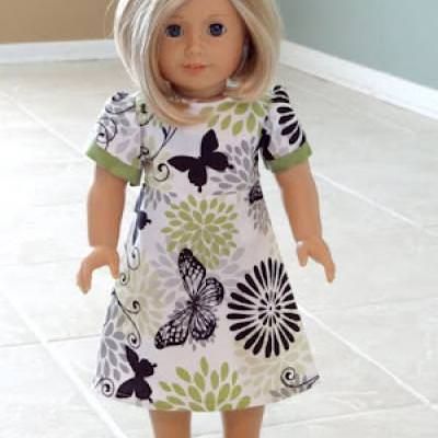 a doll is standing on the floor in a room with tile floors and white tiles