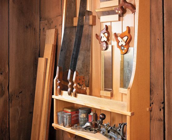 a wooden shelf filled with lots of different types of knives