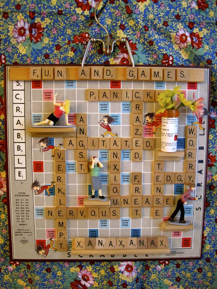 a scrabble board with people on it and flowers in the backgroud