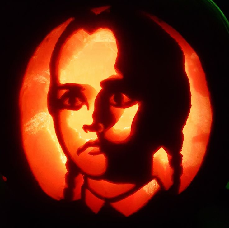 a pumpkin carved to look like a woman's face