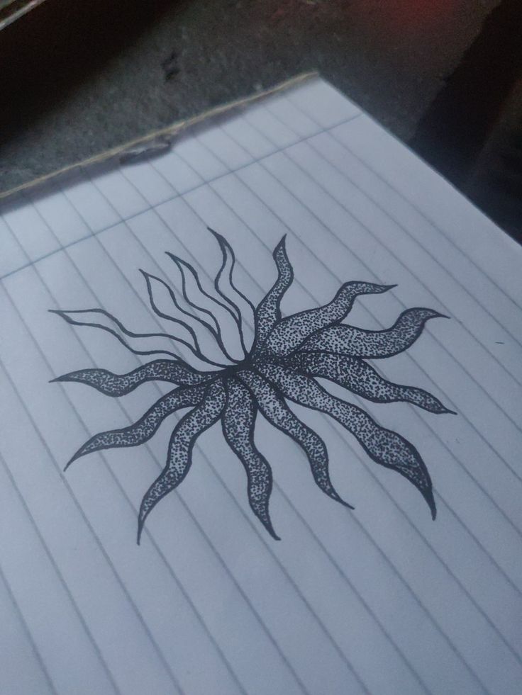 a drawing of a sunflower on lined paper