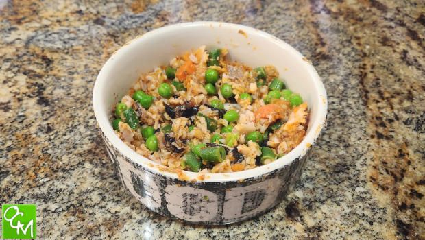 a bowl filled with rice and vegetables on top of a counter