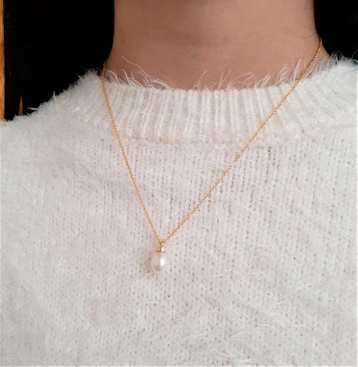 This dainty handmade necklace features a genuine Freshwater Pearl gemstone handmade using 14k Gold Filled in any length that you choose. This delicate solitaire necklace is handmade with just a simple wire wrap to give it the perfect delicate look. Beautiful worn alone or layered with other necklaces. Makes a great gift to add to any gemstone lover's collection. Perfect to gift for Christmas, Valentine's Day, Mother's Day, and more! Gemstone: Freshwater Pearl Gemstone Size: 8.0 mm Pearl Shape: T Handmade Dainty Pearl Necklace, Dainty Pearl Pendant Charm Necklace, Dainty Pearl Pendant Charm Necklace For Everyday, Delicate 14k Gold Filled Charm Necklaces With Pearl Pendant, Delicate 14k Gold-filled Charm Necklace With Pearl Pendant, Minimalist Handmade Pearl Necklace, Simple 14k Gold-filled Necklace, Minimalist Pearl Pendant Charm Necklace For Everyday, Minimalist Yellow Gold Wire Wrapped Necklace