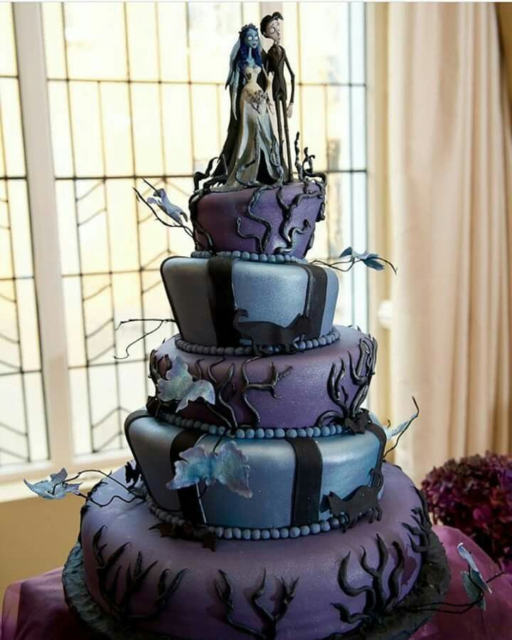 a three tiered cake with purple frosting and black icing, decorated with spooky decorations