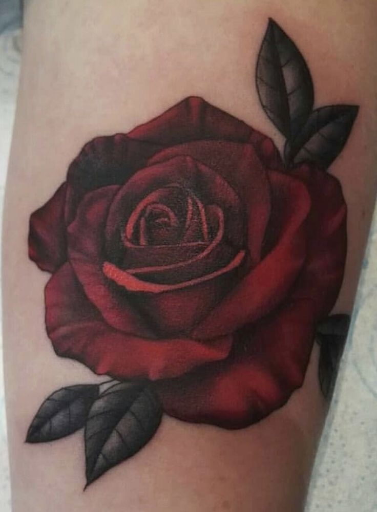 a red rose tattoo on the leg