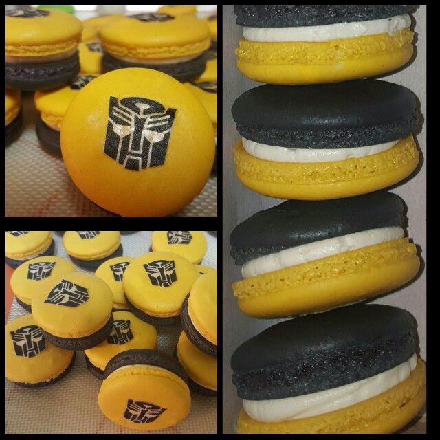 an assortment of yellow and black decorated macaroons