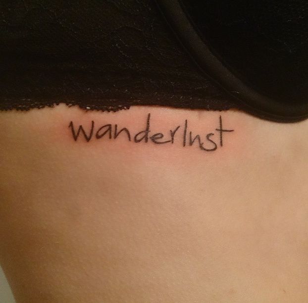 a woman's lower back with the word wanderlist written on her left side