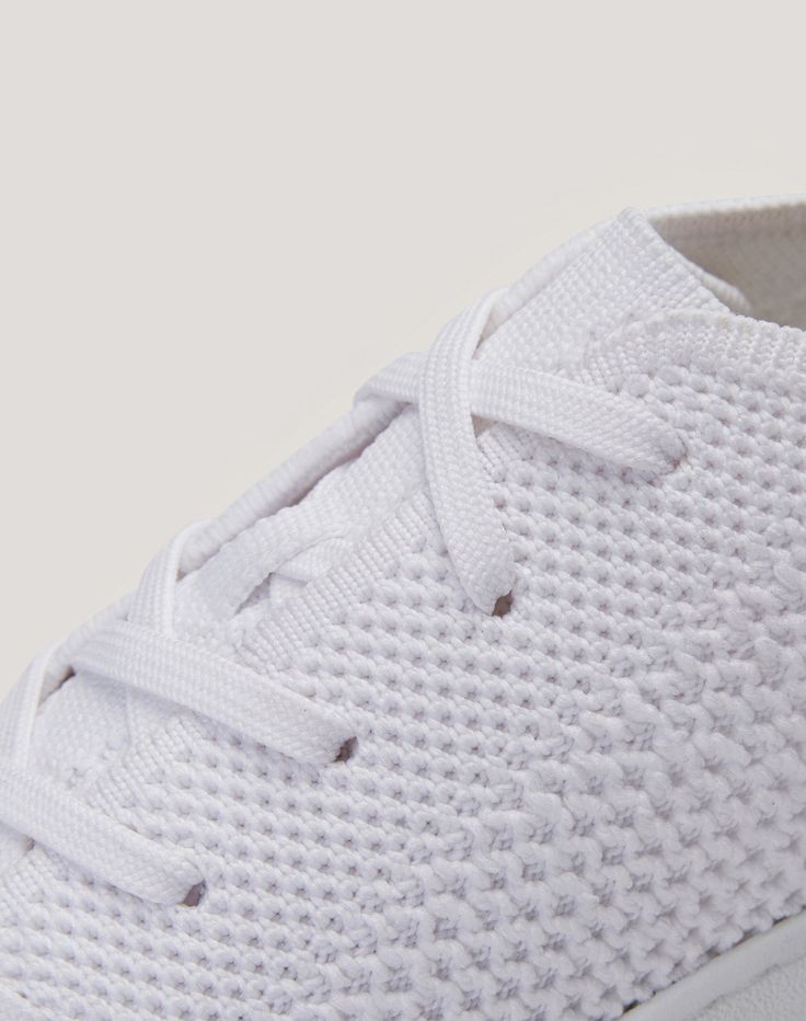 The classic clean white sneaker. This reimagined staple shoe features a relaxed silhouette, and goes beyond looks: its single-layer knit upper is fully breathable and the ultra-light sole makes this your perfect companion for city explorations. A minimalist design with maximal comfort. Comfortable White Slip-on Sneakers With Rubber Waffle Outsoles, Sporty White Slip-on Sneakers For Everyday, Everyday White Textile Sneakers, Comfortable White Slip-on Sneakers With Boost Midsole, White Textile Slip-on Sneakers With Textured Sole, Staple Shoes, Product Development Process, Knit Sneakers, Cloud White