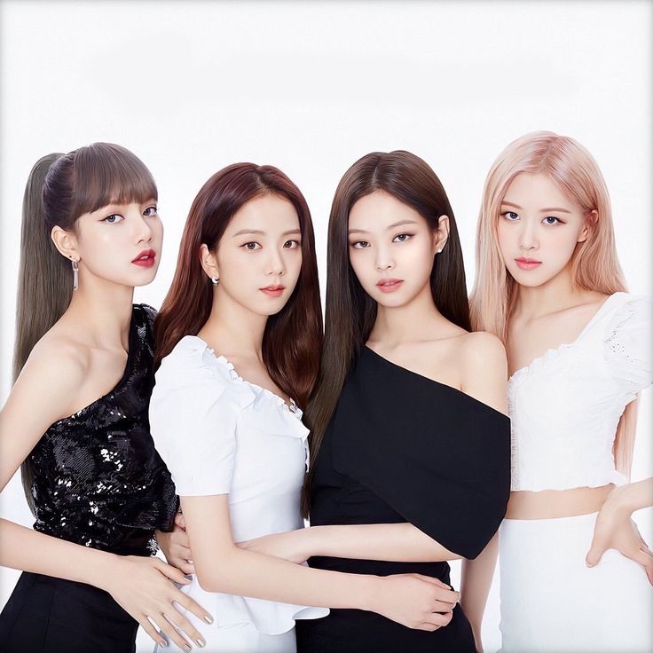 three girls in black and white outfits posing for the camera with their arms around each other