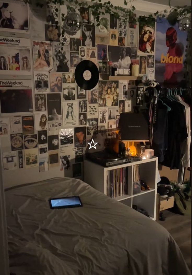 a bed room with a neatly made bed and lots of pictures on the wall