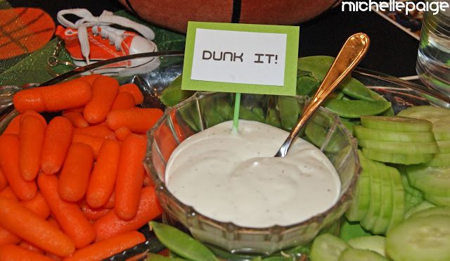 carrots, celery, and dip are on display at a reception table