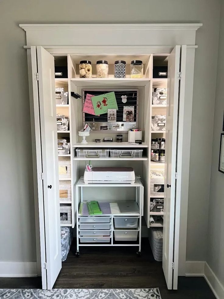 an organized closet with shelves and drawers in the corner, filled with crafting supplies