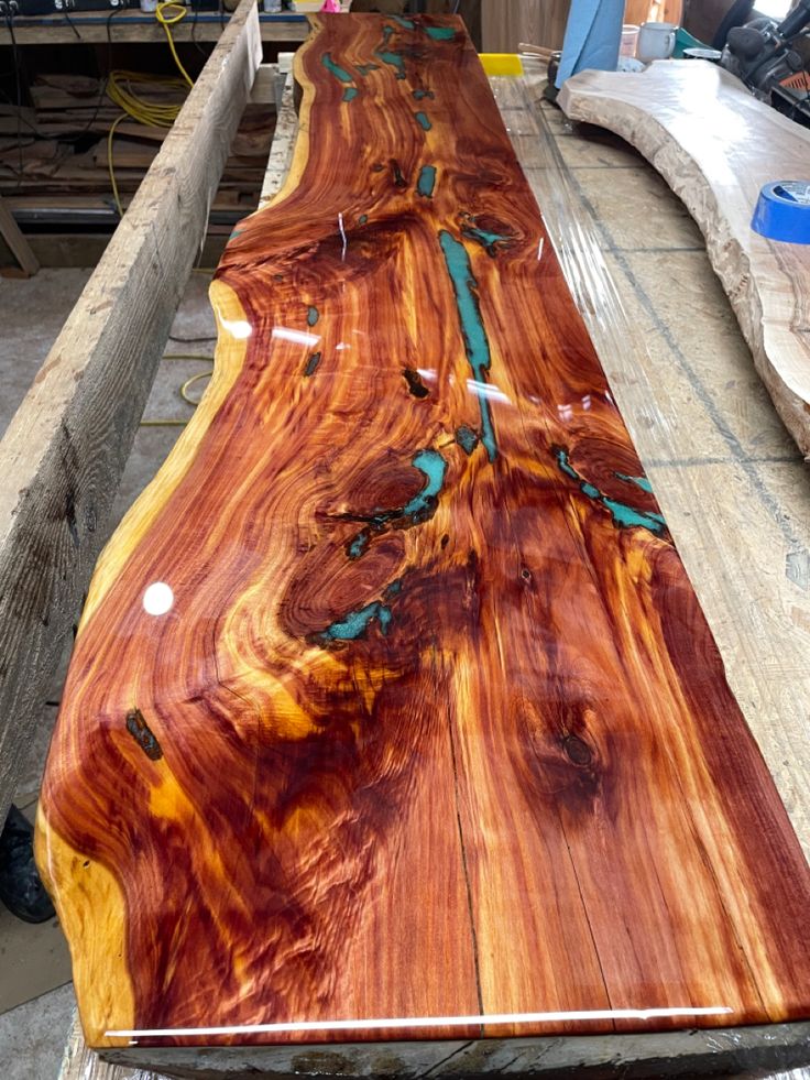 a long wooden table sitting on top of a piece of wood