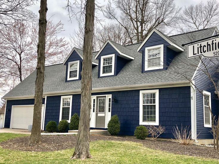 a blue house with white windows and a sign that says lithick street on it