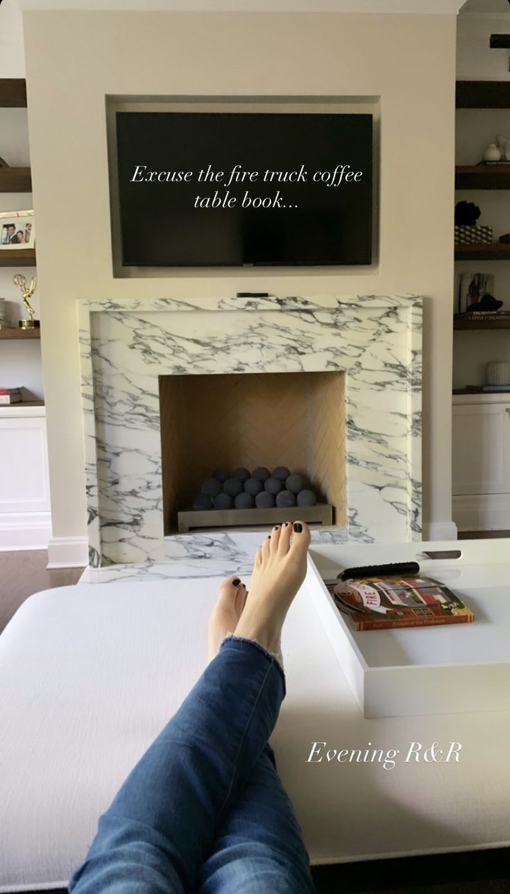 a person laying on top of a bed with their feet propped up against the edge