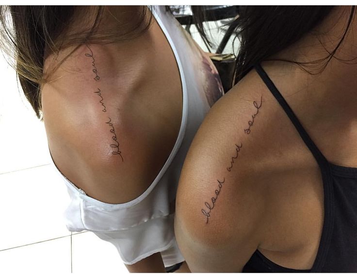 two women with tattoos on their backs, one has the word love written in cursive writing