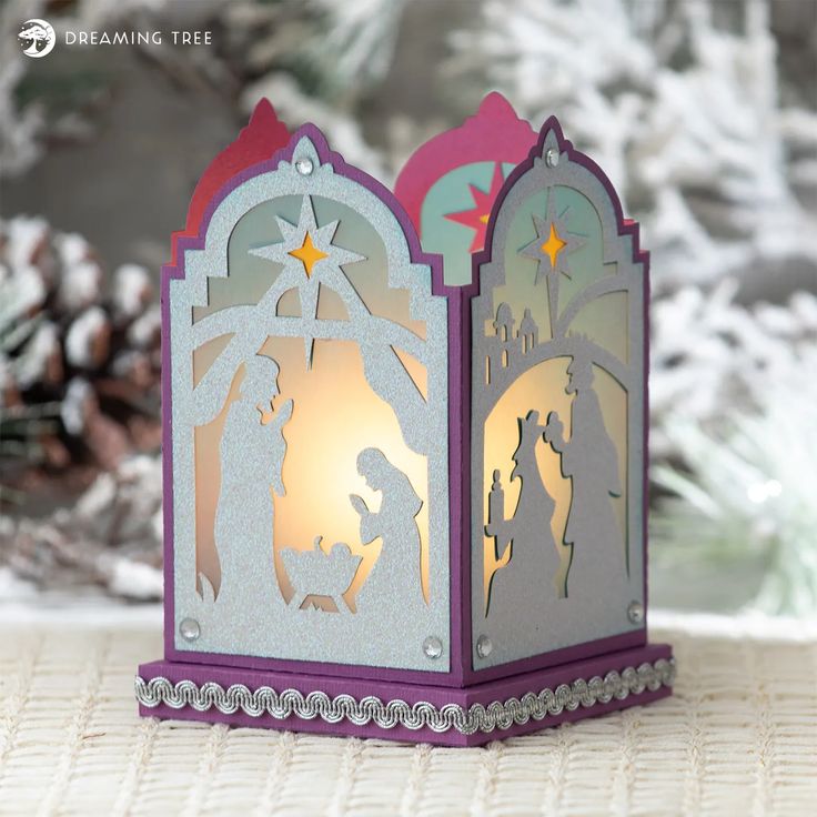 a lit up christmas card with a nativity scene on it's front and side