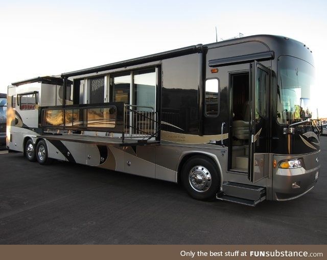 a large silver bus parked in a parking lot