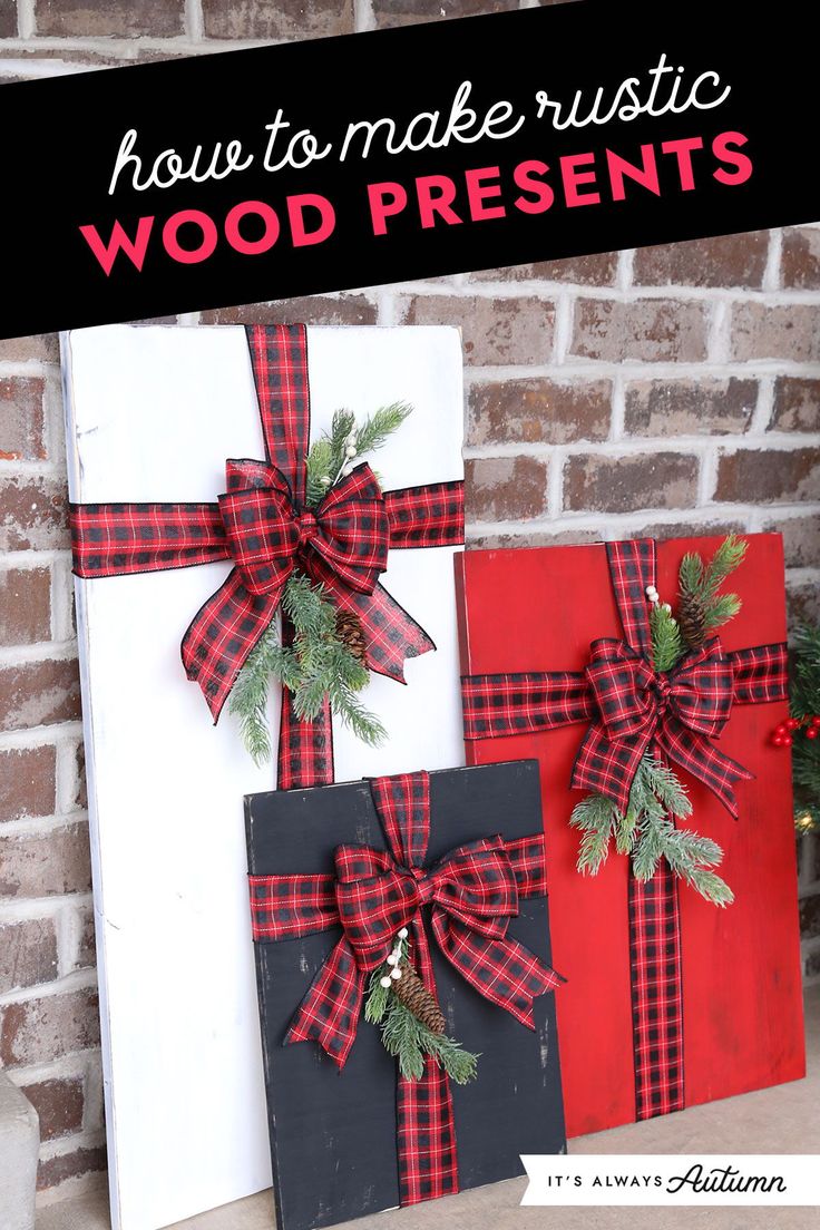 two wooden presents with red and black bows on them are sitting next to a brick wall