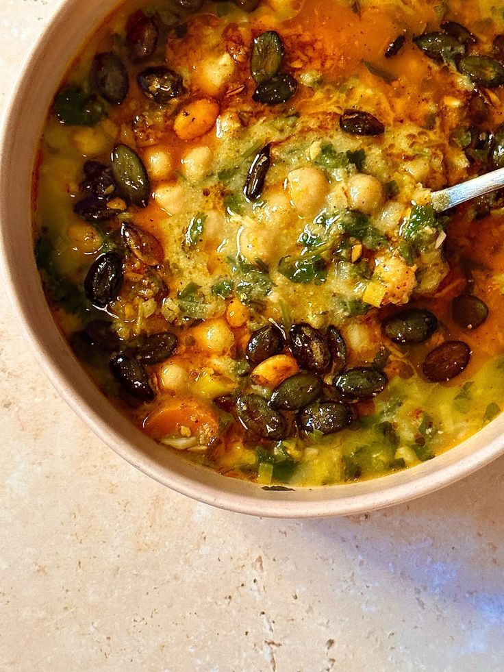 a white bowl filled with food on top of a table