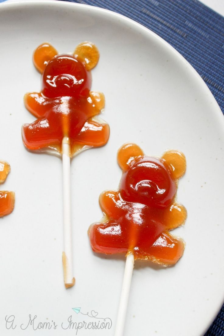 three candies shaped like teddy bears on a plate with toothpicks in them