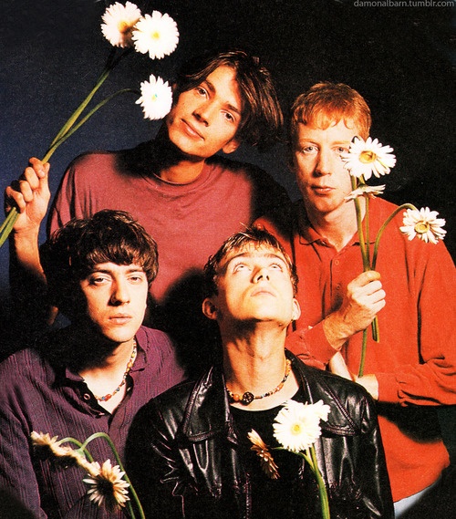 an album cover with three men standing in front of flowers and one man looking up at the sky