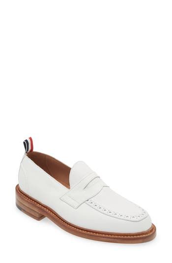 A tricolor grosgrain pull loop brings the label's signature flair to this calfskin-leather loafer detailed with classic broguing at the apron toe. Leather upper and lining/leather and synthetic sole Made in the UK Designer Shoes White Calf Leather Loafers For Work, Luxury Loafers With Contrast Sole For Work, White Calf Leather Loafers With Almond Toe, Luxury White Loafers With Stitched Sole, White Tassel Loafers With Leather Sole For Business, White Tassel Loafers With Brogue Detailing For Formal Occasions, White Almond Toe Loafers In Calf Leather, Classic White Loafers With Leather Sole, White Classic Loafers With Leather Sole